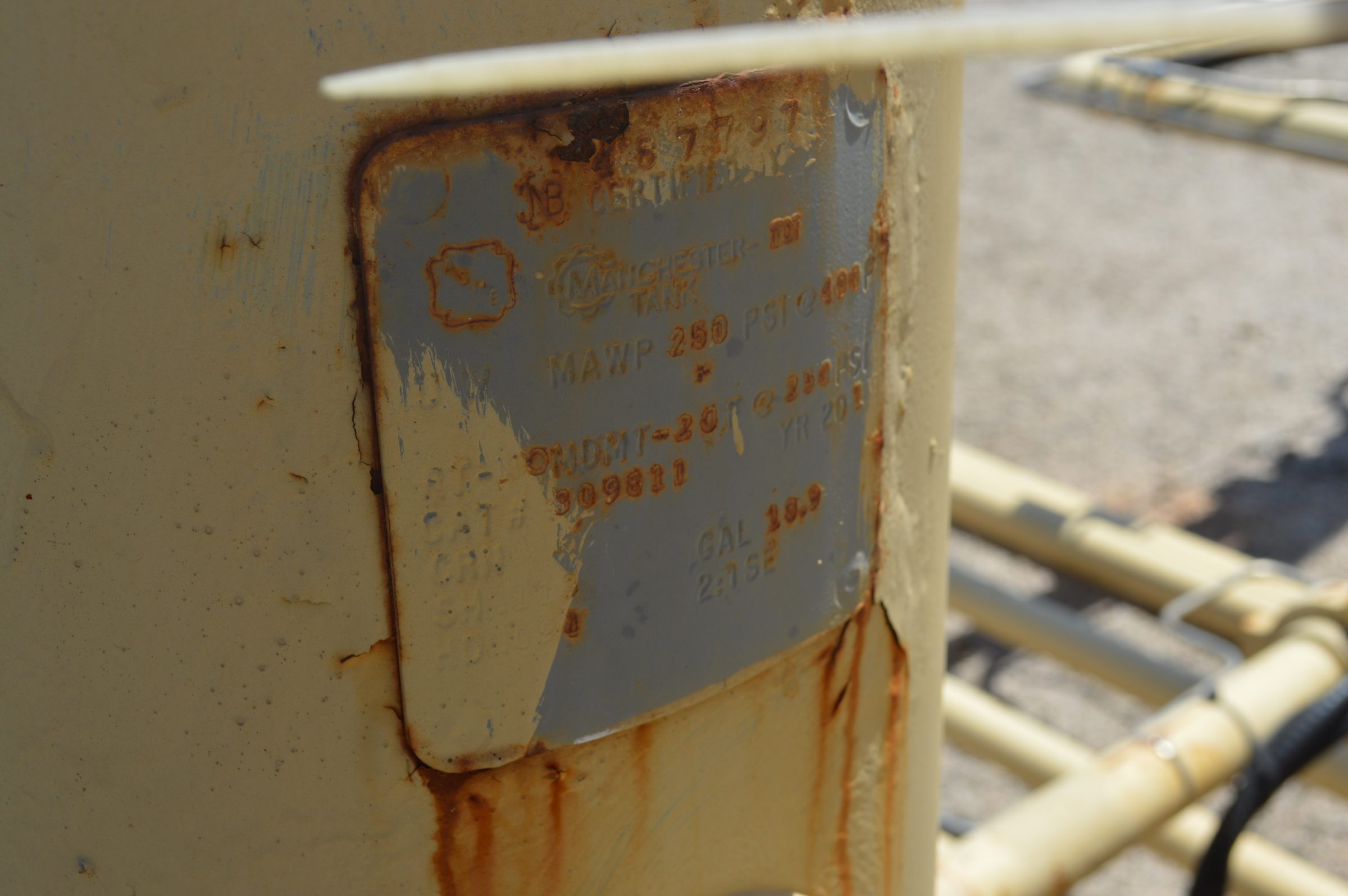 ASME nameplate on a production vessel showing capacity and serial number
